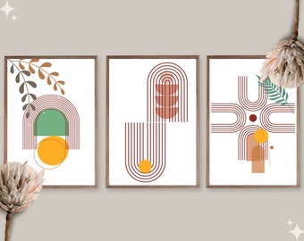 May include: A set of three framed art prints with abstract designs. The prints feature geometric shapes in earthy tones, such as arches, circles, and lines, with green and orange accents. The artwork is set against a white backdrop.