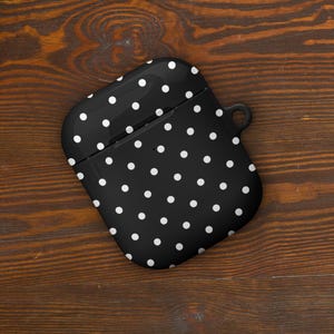May include: Black and white polka dot silicone case for AirPods.