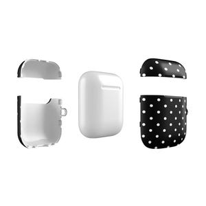 May include: A white Airpods case with a black and white polka dot design. The case is shown in three parts: the top, the bottom, and the inside.
