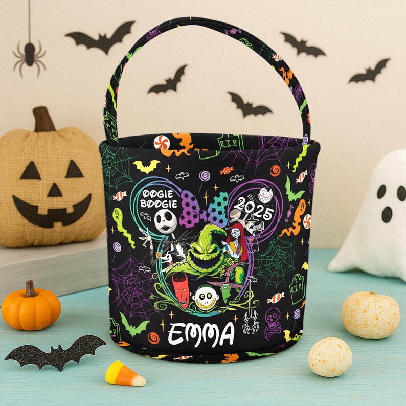 May include: Black Halloween trick-or-treat bag with a handle, featuring a colorful design with characters and the name "EMMA". The bag has a spooky theme with bats, spiderwebs, and the text "DOGIE BOOGIE" and "2025".