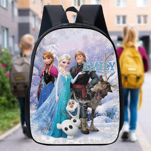 May include: A black backpack with a colorful design featuring characters from the movie Frozen. The backpack has a zipper closure and a name tag that says "EMILY".