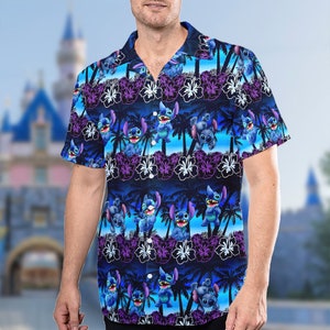 May include: A blue, short-sleeved button-down shirt with a tropical print featuring Stitch from Lilo & Stitch. The print includes palm trees, flowers, and Stitch in various poses.