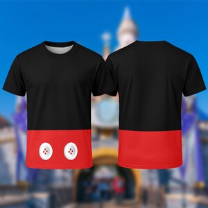 A black and red t-shirt with a Mickey Mouse design on the front and back, set against a blurred background of a castle.