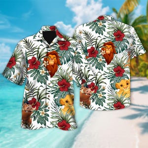 May include: A white button-up shirt with a tropical print featuring Simba, Pumbaa, and Timon from The Lion King. The print includes green leaves, red hibiscus flowers, and white flowers.