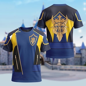 May include: A blue and yellow t-shirt with a gold emblem on the front and back. The front features a diagonal zipper design and a shield emblem. The back displays a gold character design on a yellow and blue background. The shirt has short sleeves.