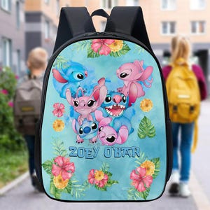 May include: Black backpack featuring a colorful illustration of cartoon characters in shades of blue and pink, surrounded by floral accents. The name "ZOEY O'BAR" is printed on the front. The backpack has black straps and a top handle.