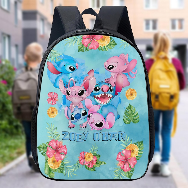 May include: Black backpack featuring a colorful illustration of cartoon characters in shades of blue and pink, surrounded by floral accents. The name "ZOEY O'BAR" is printed on the front. The backpack has black straps and a top handle.