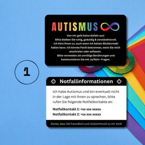 May include: A black card with the word "AUTISMUS" in rainbow colors and an infinity symbol. The card also includes text in German explaining that the person has autism and may need help communicating. The card also includes two emergency contact numbers.
