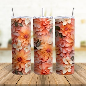 May include: Three stainless steel tumblers with a floral design. The tumblers are decorated with a pattern of peach and white flowers.