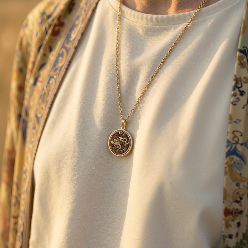 taurus woman zodiac gold pendant necklace, polished with high reflectivity on rim and bail; central field shows darker, non-reflective finish, circular pendant with raised relief figure in flowing garment, surrounded by concentric decorative borde...