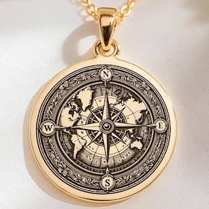Colgante de mapa del mundo con brújula en oro macizo de 14 quilates, ideal como regalo para viajeros apasionados por los viajes.