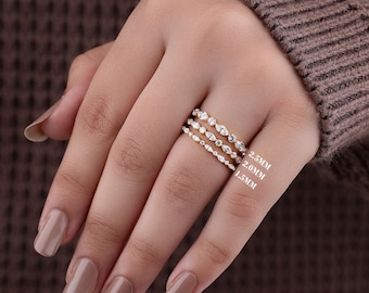 May include: Three gold-toned stackable rings featuring marquise and round-cut clear stones. The rings are labeled with widths of 2.5mm, 2.0mm, and 1.5mm, indicating the varying sizes of the bands and stone settings arranged in a vertical stack.