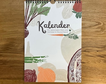 May include: A calendar with a spiral binding, featuring illustrations of vegetables and fruits. The word "Kalender" is prominently displayed, with additional text in German. The design includes images of beets, asparagus, onions, and a strawberry, set against a white background.