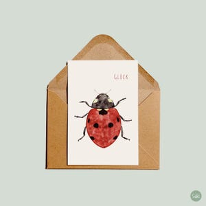 Postkarte Marienkäfer mit dem Schriftzug Glück