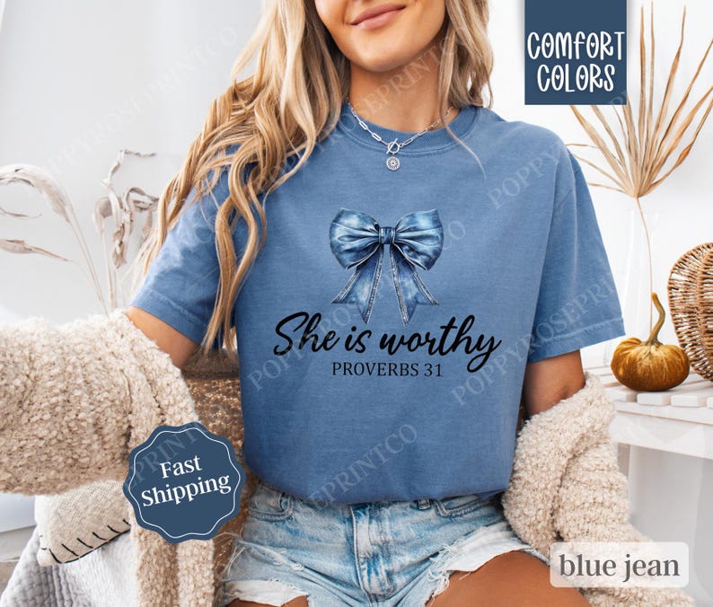 May include: A blue jean-inspired bow with a white background and the text "She is worthy Proverbs 31" on a blue t-shirt.
