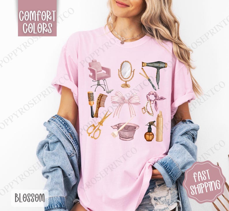 May include: A pink t-shirt with a graphic design of hair salon tools and equipment, including a hair dryer, scissors, a hairbrush, a hair dye bowl, a hairspray bottle, a mirror, a hair tie, and a salon chair. The text "COMFORT COLORS" is at the top of the shirt.