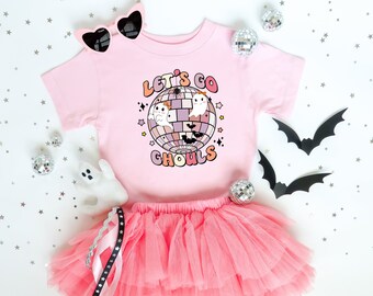 May include: Pink tutu skirt and a pink t-shirt with a disco ball graphic and the text "Let's Go Ghouls".