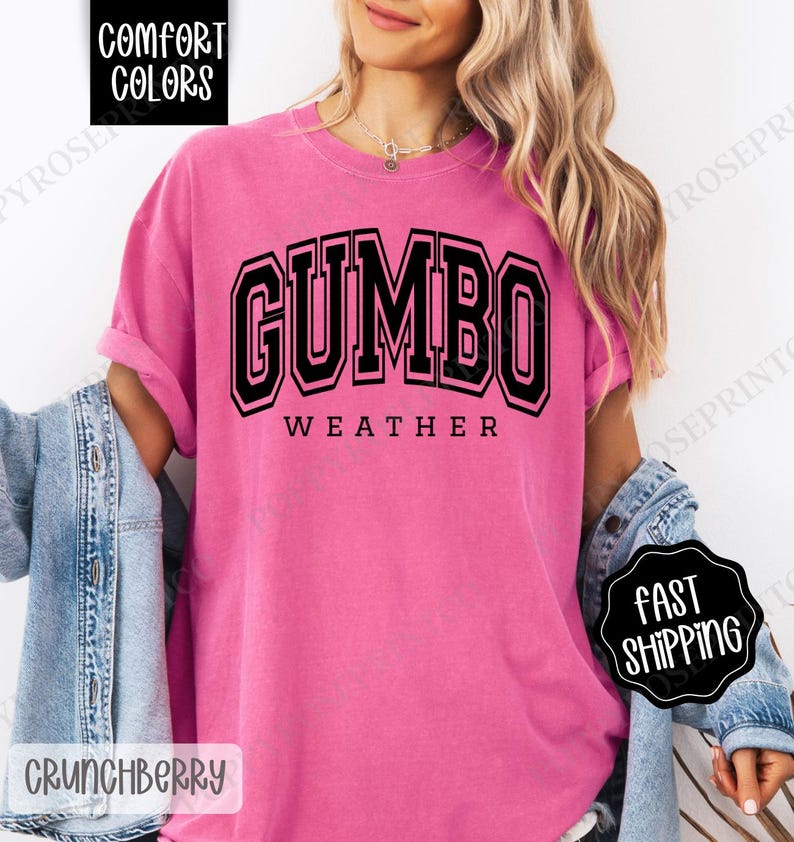 May include: A pink t-shirt with black text that reads "GUMBO WEATHER".