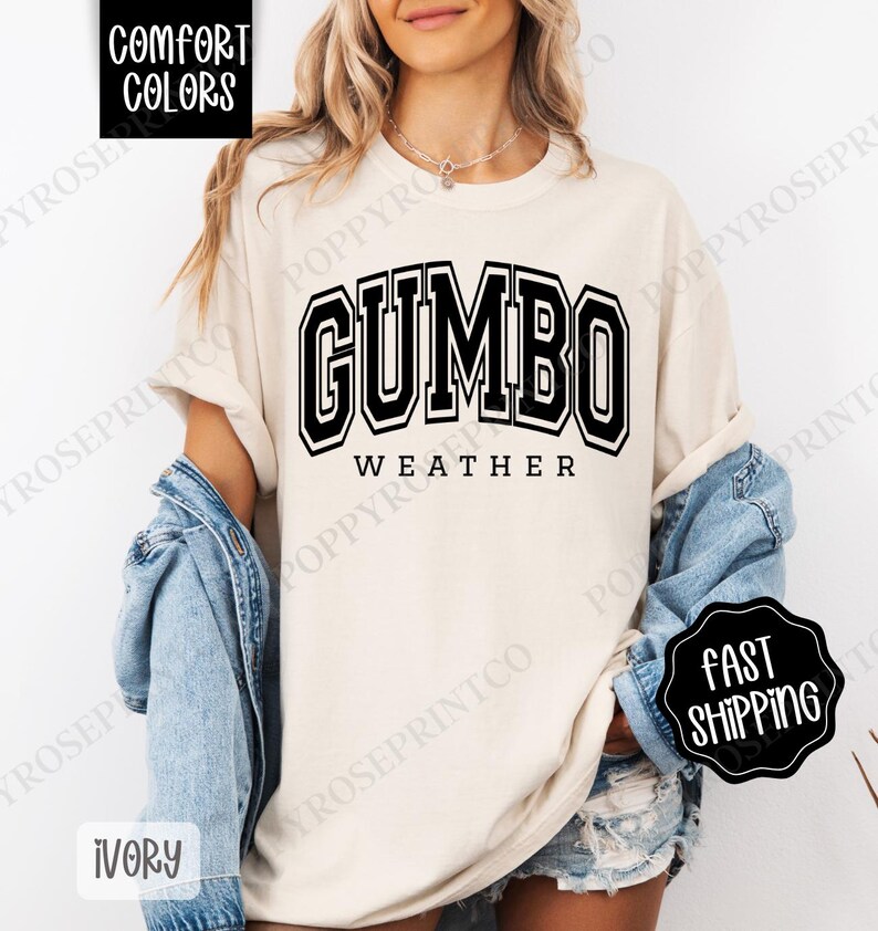 May include: A white t-shirt with black text that reads "GUMBO WEATHER" in a collegiate-style font.