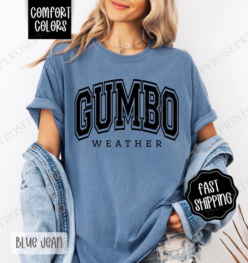 May include: A blue t-shirt with the text "GUMBO WEATHER" in black block letters.