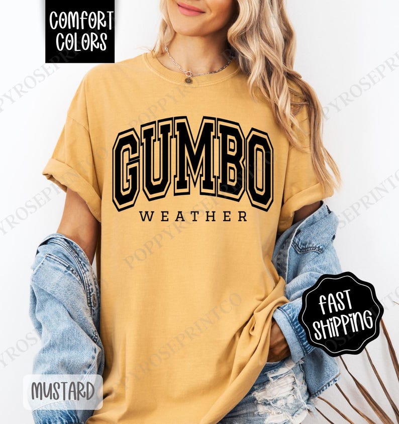 May include: A mustard yellow t-shirt with black text that reads "GUMBO WEATHER".