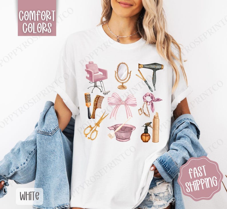 May include: White t-shirt with a pink and gold illustration of hair salon tools, including a hair dryer, scissors, combs, a hair dye bowl, and a hairspray bottle. The text "COMFORT COLORS" is in the upper left corner of the image.