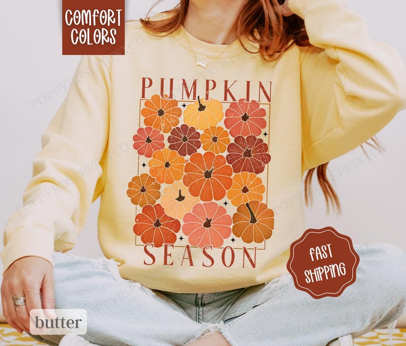 May include: A yellow sweatshirt with the text "Pumpkin Season" and a graphic of stylized pumpkins in shades of orange, red, and brown.
