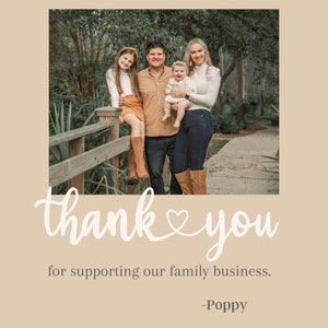 May include: A family of four, including a young child, stands on a wooden bridge. The parents are smiling and the children are looking at the camera. The family is wearing casual clothing. The text "thank you" with a heart symbol is written in white on a beige background. The text "for supporting our family business." is written in black below the thank you message. The text "Poppy" is written in black below the business message.
