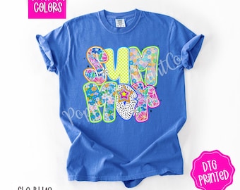 May include: A blue t-shirt with the word "SUMMER" in colorful, patterned letters. The letters are outlined in yellow and have a retro, 70s vibe. The shirt is a comfort colors brand and is labeled "Flo Blue".