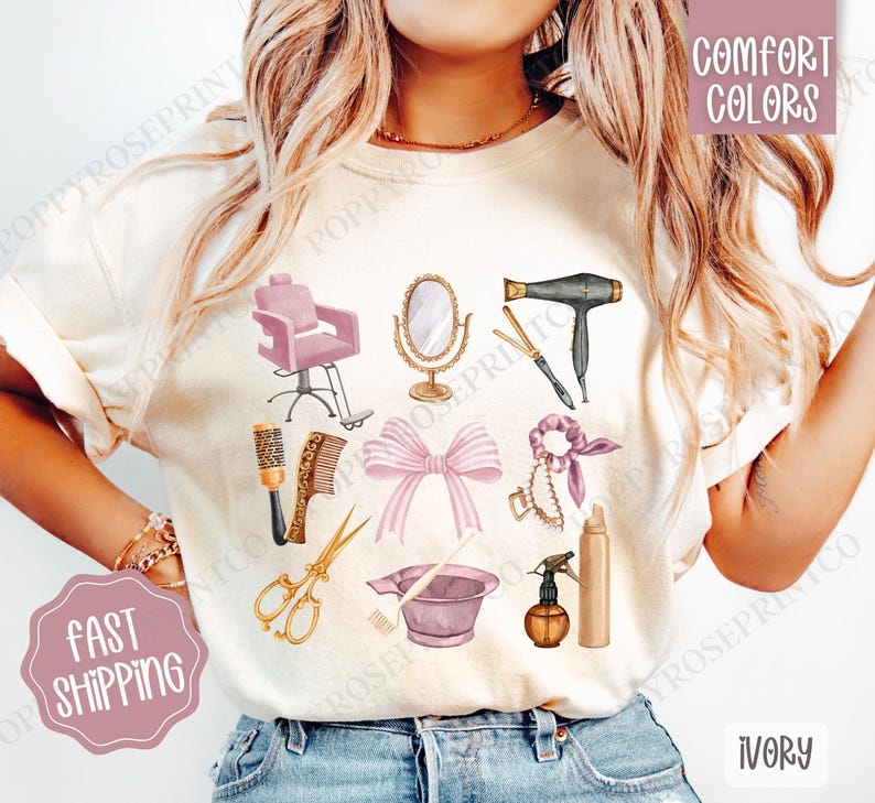 May include: A white t-shirt with a design of hair salon tools, including a hair dryer, scissors, combs, a hair dye bowl, and a hair tie. The text "Comfort Colors" is in the top right corner of the image. The t-shirt is ivory.