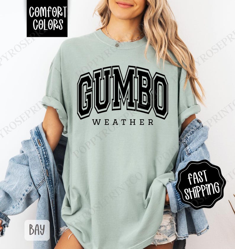May include: A light green t-shirt with black text that reads "GUMBO WEATHER" in a collegiate font.