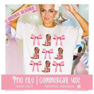 May include: A white t-shirt with a design of pink bows and brown cowboy boots. The design is repeated across the shirt.  The shirt is being worn by a person.