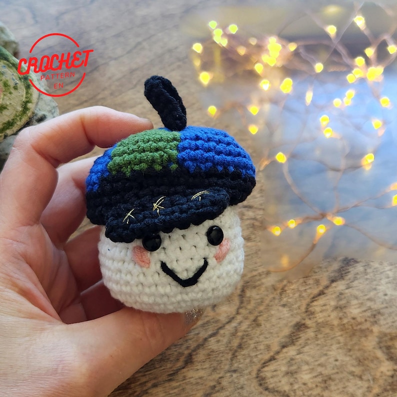 Front view of the finished crochet NASA RISE mascot rover with large safety eyes.