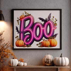 May include: A framed Halloween-themed artwork with the word "Boo" in a neon-style font, featuring purple and pink gradients. The artwork includes orange pumpkins, bats, and decorative foliage.