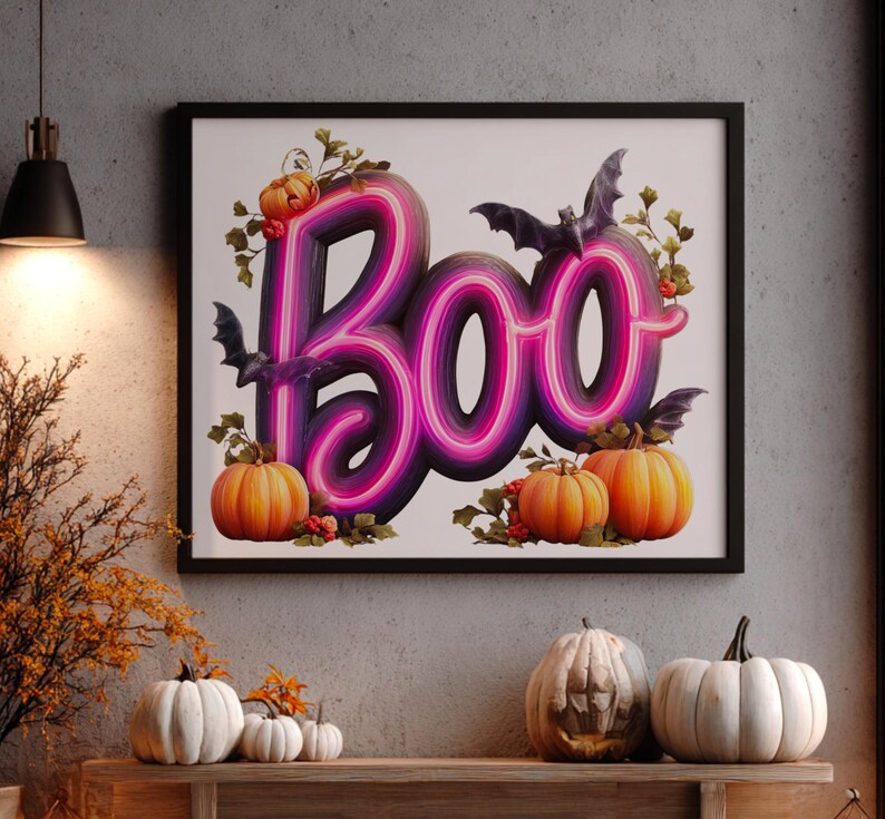 May include: A framed Halloween-themed artwork with the word "Boo" in a neon-style font, featuring purple and pink gradients. The artwork includes orange pumpkins, bats, and decorative foliage.