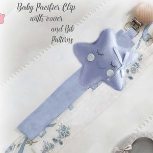 May include: Baby pacifier clips with various designs, including a star, pig, cloud, and cat. The clips are in pastel colors and feature a pacifier attachment. The image also shows a bib pattern and the text "Baby Pacifier Clip with cover and Bib Patterns."