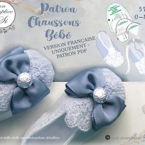 May include: A pair of baby booties with a blue bow and lace trim, with a pearl-like embellishment. The image also includes a pattern for the booties, with text that reads "Patron Chaussons B&eacute;b&eacute;" and "5 Tailles 0-18 Mois".