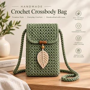 May include: A sage green crochet crossbody bag featuring a rectangular flap, a thick braided shoulder strap, and a decorative wooden bead accent with a cream-colored macrame leaf charm hanging from the center of the front closure.