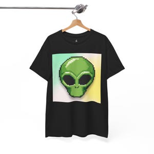 May include: Black t-shirt with a green pixelated alien head graphic on a colorful background.