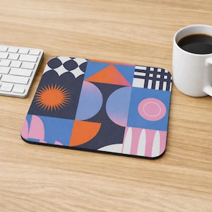 May include: A rectangular mouse pad featuring a geometric pattern with a dark blue background. The design includes a bright orange sunburst, various semi-circles, triangles, and grid patterns in shades of pink, light blue, and white.