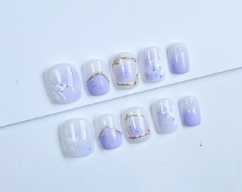 Uñas postizas con diseño floral morado: Juego de uñas de lujo con diseño de ojo de gato blanco