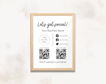 May include: A white sign with a wooden frame, featuring the text "Let's get social!" and "Your Business Name". The sign also includes a logo placeholder, social media icons with handles, QR codes for visiting the website and leaving a review, and the text "Thanks for supporting our small business!"