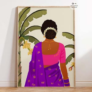 May include: An art print featuring a woman in a traditional Indian sari, viewed from the back. The woman wears a pink blouse and a purple sari with gold lettering. The background includes banana leaves and yellow flowers, all within a wooden frame.