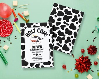 Può includere: Un invito di compleanno con stampa di mucca in bianco e nero con il testo "HOLY COW! OLIVER IS TURNING ONE!" e dettagli per la festa, tra cui data, ora, luogo e indirizzo.