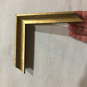 gold leaf scoop frame with distressing and black side panel and inside lip