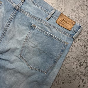 May include: Light blue denim jeans with a back pocket and a brown leather patch that says "Polo Ralph Lauren Authentic Denim Goods Original Quality".