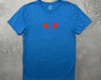 Camiseta azul vintage Oakley con elipse roja grande (años 2000)