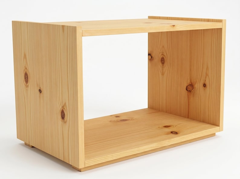 May include: A rectangular open-front storage unit constructed from light-coloured natural pine wood. The piece features visible wood grain patterns and several dark circular knots throughout the side and base panels, with a simple box-like frame.