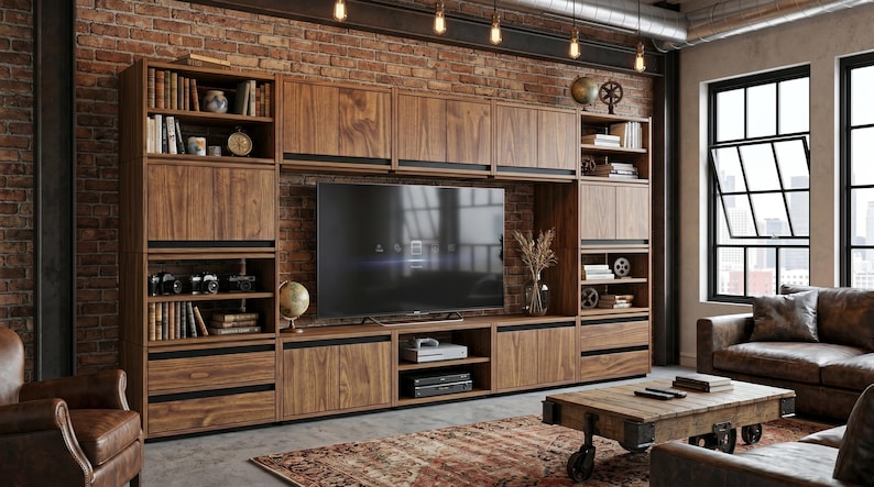 May include: A large wall-mounted wooden entertainment unit featuring a central television compartment, multiple open shelving units, and lower storage cabinets with dark horizontal accents, constructed from a rich brown wood grain finish.