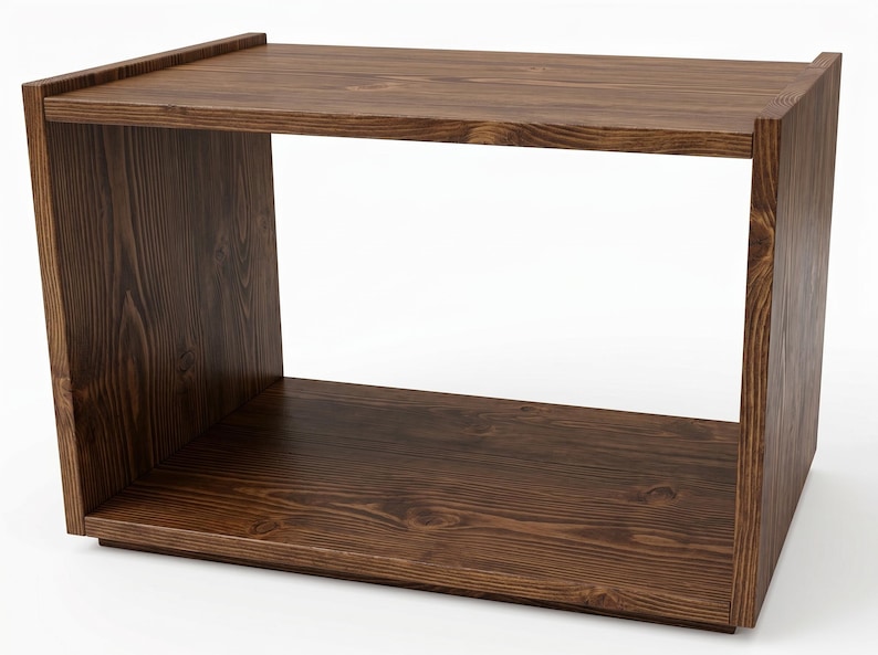 May include: A rectangular open-front storage unit crafted from dark brown wood with a visible grain pattern. The piece features a flat top surface, two solid side panels, and a base, creating a single large open compartment for storage or display.
